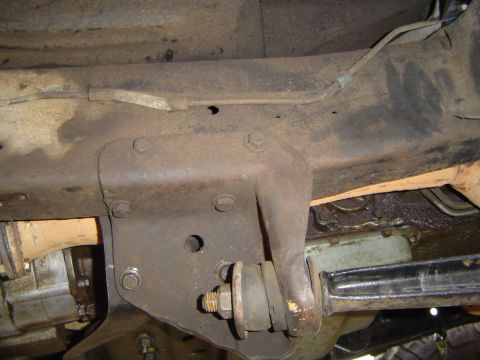 1979 Ford Bronco - Close-up view of the rusty undercarriage and suspension system of a vehicle.
