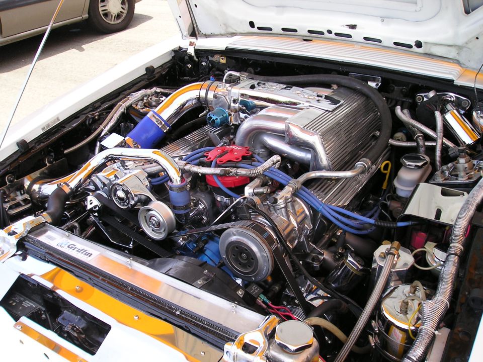 Engine bay with chrome intake manifold, polished valve covers, and Griffin radiator