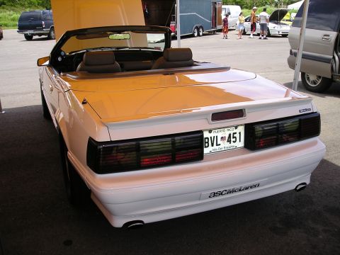 2001 Ford Mustang - A white convertible with a spoiler and aftermarket black taillights is shown from the rear.