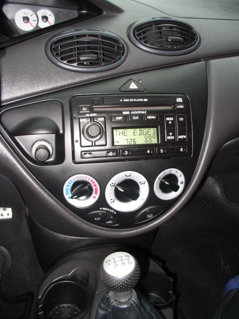 2003 Ford Focus - The interior of a 2003 Ford Focus, showing the center console with the radio and climate controls.