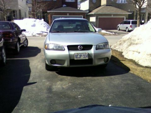 2002 Nissan SE-R - A silver 2002 Nissan SE-R is parked in a driveway with snow piles visible in the background.