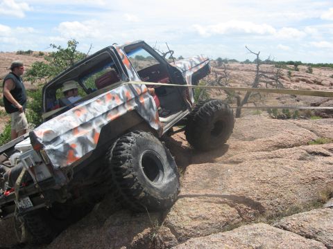 1979 Ford Bronco - This heavily modified off-road vehicle navigates a challenging rocky landscape, demonstrating its off-road capabilities.