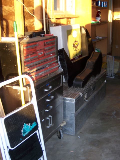 1991 Ford Bronco - A collection of tools and storage items are organized in a garage setting.