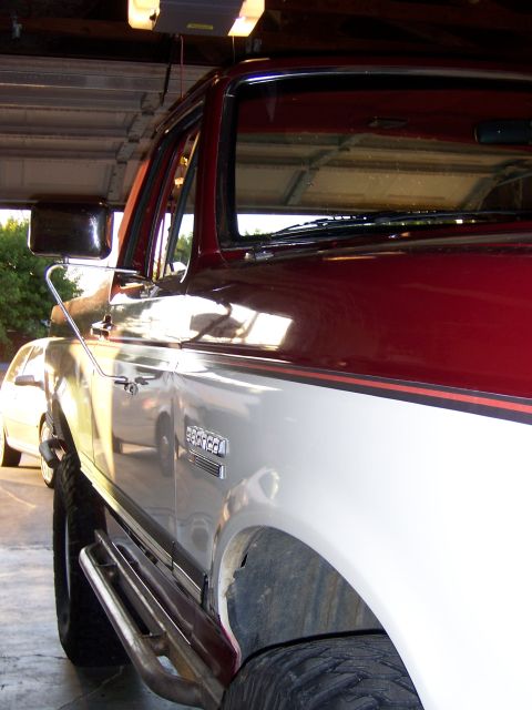 1991 Ford Bronco - Side profile of a 1991 Ford Bronco with two-tone paint and aftermarket running boards.