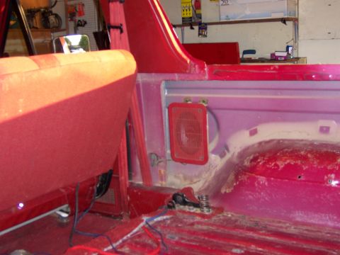 1991 Ford Bronco - The interior of a red vehicle shows exposed wiring and a speaker grille, with no clear year identification.