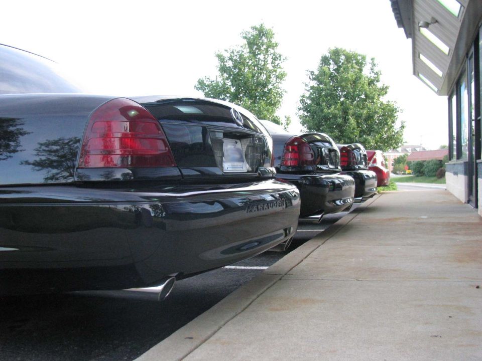 Three black Mercury Marauders parked in a row, viewed from the rear