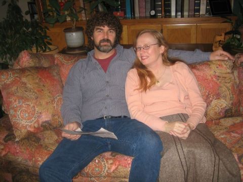 1990 Ford Bronco - A couple sits together on a couch in a living room setting.