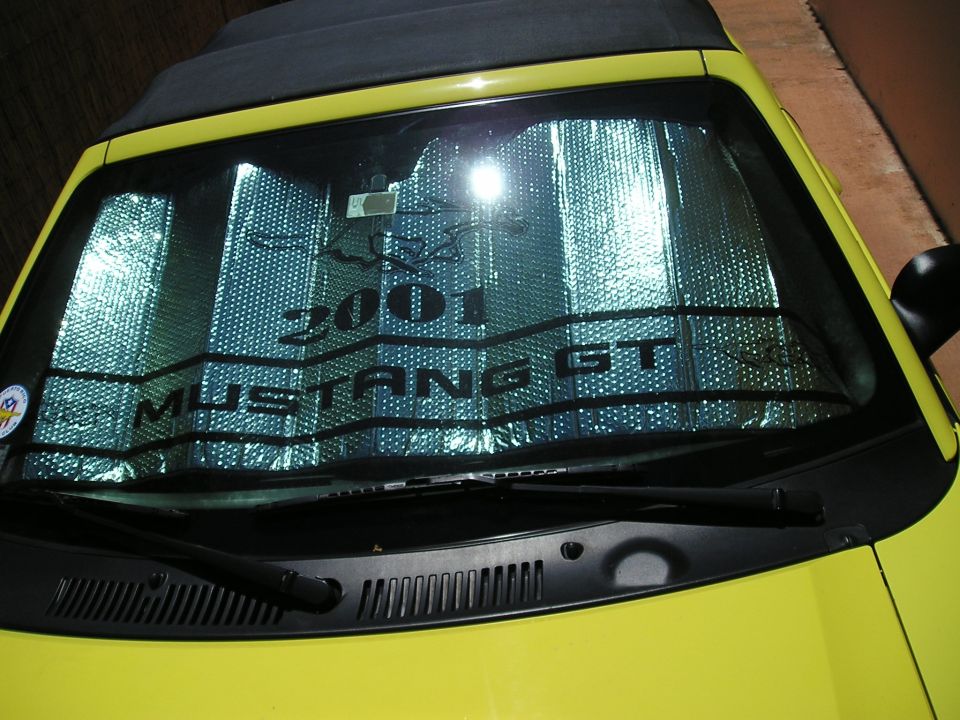 Yellow 2001 Ford Mustang GT windshield with sunshade showing text