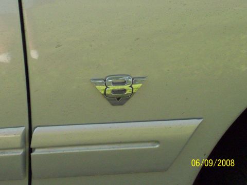 2003 Ford Crown Victoria - A V8 emblem is visible on the side of a vehicle, with a date stamp of 06/09/2008.