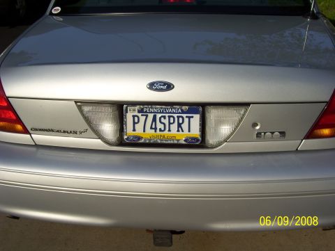 2003 Ford Crown Victoria - Rear view of a silver 2003 Ford Crown Victoria, showing the license plate and Ford emblem.