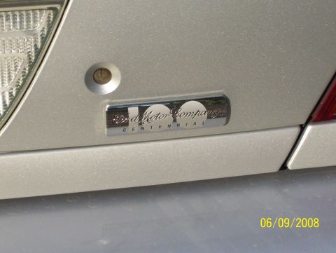 2003 Ford Crown Victoria - A Ford Motor Company Centennial emblem is visible on the rear of a silver vehicle.