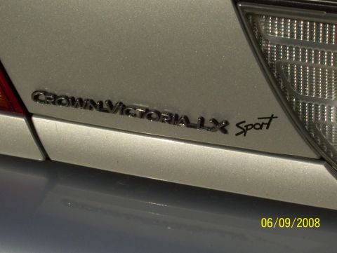 2003 Ford Crown Victoria - Rear emblem reads "Crown Victoria LX Sport" on a silver vehicle.