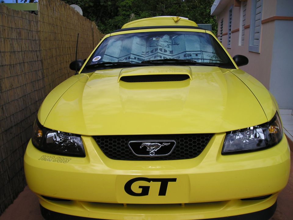 Yellow 2001 Ford Mustang GT front view with GT badge and pony emblem
