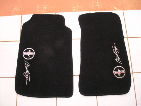 2001 Ford Mustang - Black floor mats embroidered with the Mustang logo and script are displayed on a tiled surface.