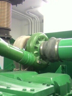 2002 Nissan SE-R - Close-up view of a green turbocharger connected to industrial piping.