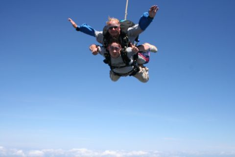 1996 Ford Bronco - Two individuals experience the thrill of skydiving high above the clouds.