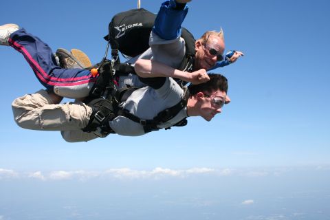 1996 Ford Bronco - Two men experience tandem skydiving with the ground far below.