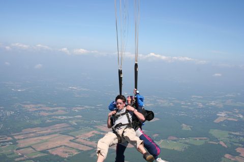 1996 Ford Bronco - Two people enjoy a tandem skydive with a vast landscape visible below.