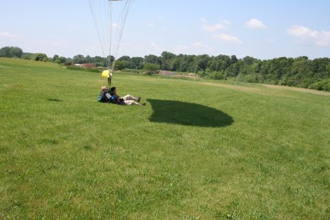 1996 Ford Bronco - Skydivers resting on the ground after landing with their parachute.