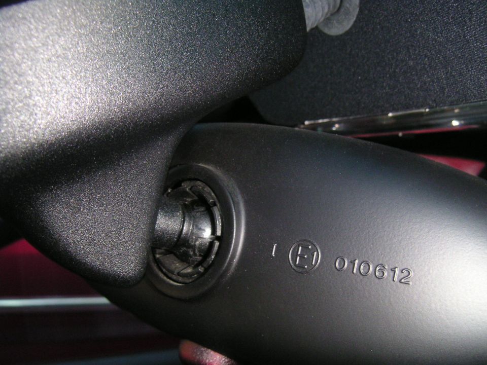 Black interior rear view mirror assembly with E1 010612 marking and Supermotors.net watermark