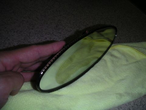 2002 BMW M3 - Interior rear view mirror being held over a yellow microfiber cloth.