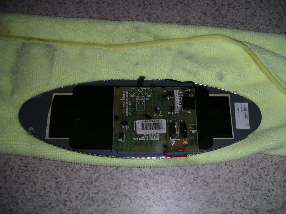 circuit board with wires and components, resting on a yellow cloth