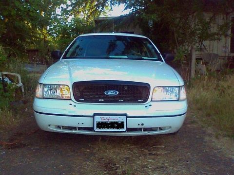 2000 Ford Crown Victoria - A white 2000 Ford Crown Victoria is parked outdoors, facing the camera.