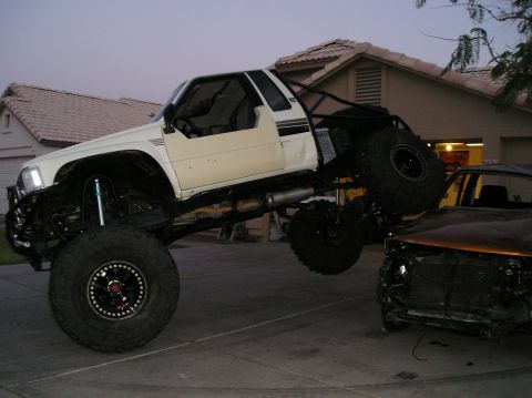1986 Toyota Hilux - Modified 1986 Toyota Hilux with custom roll cage and suspension modifications.