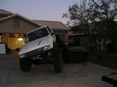1986 Toyota Hilux - A heavily modified 1986 Toyota Hilux pickup truck is parked in a driveway at dusk.