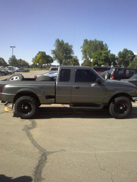 2004 Ford Ranger - This gray pickup truck is seen from the side, with spare tires loaded in the bed.