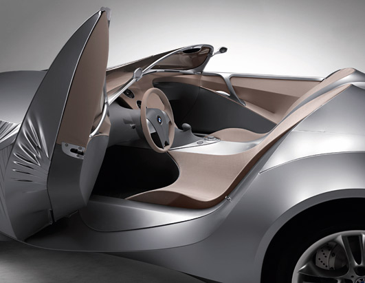 Concept car interior with open door, showing seats and steering wheel with BMW logo