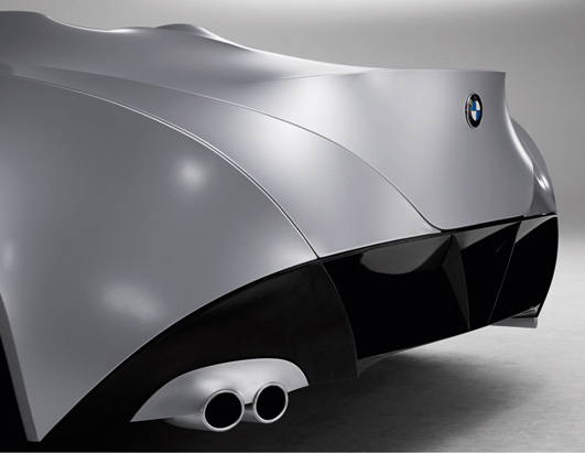 Rear view of a silver BMW concept car with dual exhaust pipes and black accents