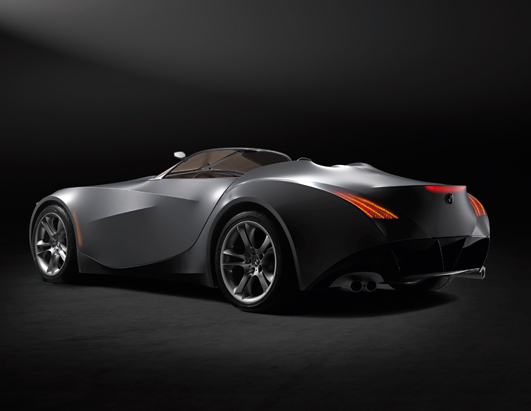 Rear 3/4 view of a silver concept sports car with sharp body lines and distinctive taillights