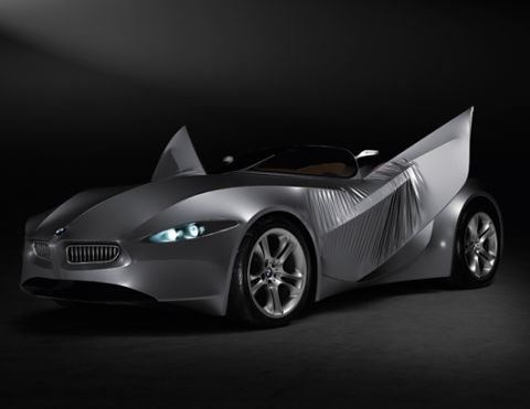 2001 Ford Crown Victoria - A futuristic BMW concept car is shown in a studio setting with dramatic lighting.