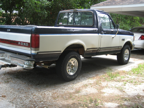 1989 Ford F-150 - Rear three-quarter view of a 1989 Ford F-150 pickup truck with a two-tone paint scheme.