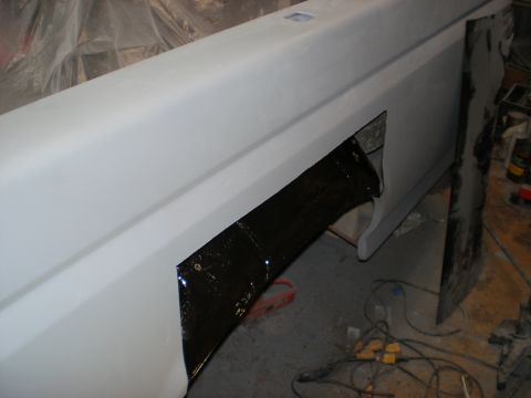 1995 Ford F-150 - Primed truck bed side panel undergoing repair or modification.