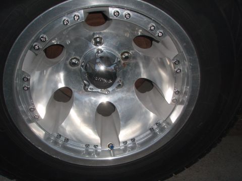 1987 Ford Bronco - A custom alloy wheel with a polished finish and chrome center cap is shown.