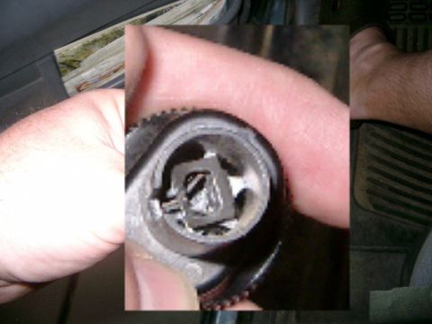 1995 Ford Bronco - Close-up of a winch remote control mechanism held by a hand.