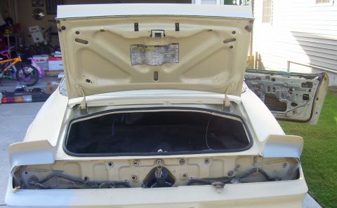 1979 Chevrolet Camaro - The rear of a 1979 Chevrolet Camaro is shown with the trunk open and the driver's side door removed.