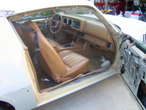 1979 Chevrolet Camaro - Interior view of a 1979 Chevrolet Camaro showing tan seats, dashboard, and door panel.