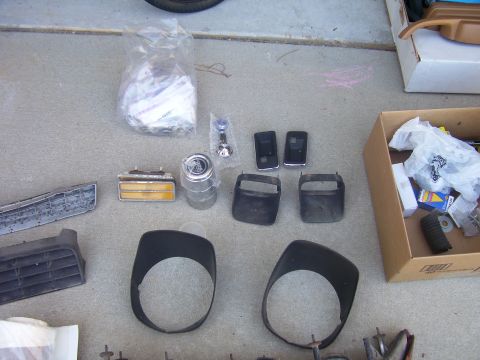 1979 Chevrolet Camaro - Collection of vehicle parts, possibly for a 1979 Chevrolet Camaro, laid out on a driveway.