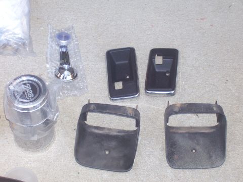 1979 Chevrolet Camaro - Several car parts are laid out on a concrete surface, including a hubcap with '728' visible.