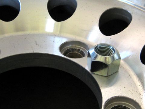 1996 Ford Bronco - Close-up of a lug nut resting on a vehicle's alloy wheel.