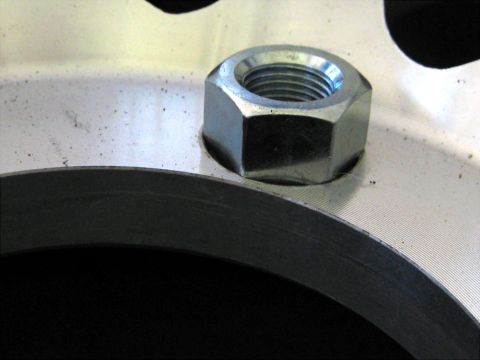 1996 Ford Bronco - A single lug nut is visible on the metallic surface of a wheel rim.