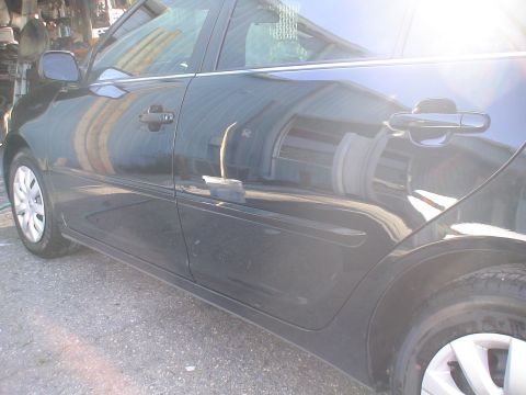 1993 Ford C-350 (Centurion Conversions) - Side view of a black car, focusing on the doors and rear fender area.