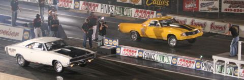1971 Ford Ranchero - A yellow 1971 Ford Ranchero races down the drag strip, its front wheels lifted off the ground.