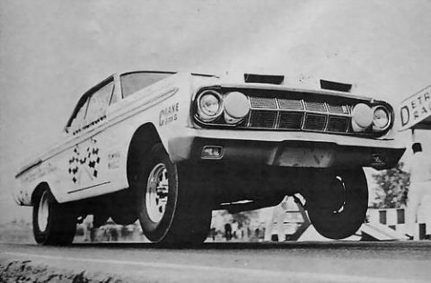 1972 Ford Ranchero - A vintage drag car launches off the line, its front wheels airborne during a race.