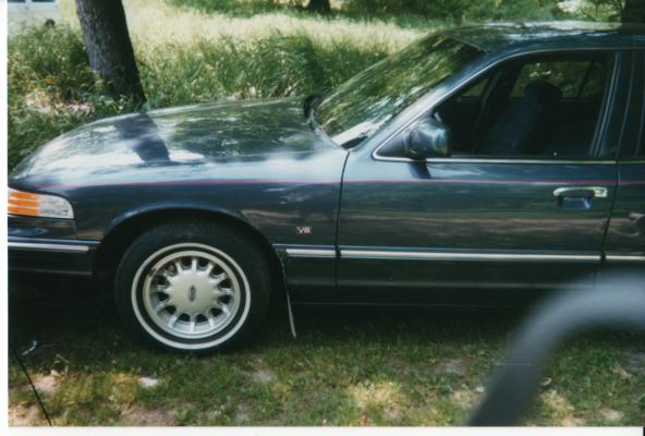 Dark blue 1996 Ford Crown Victoria sedan, side view