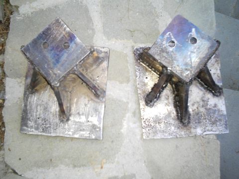 1994 Ford F-150 - Custom welded metal brackets are shown resting on a stone surface.