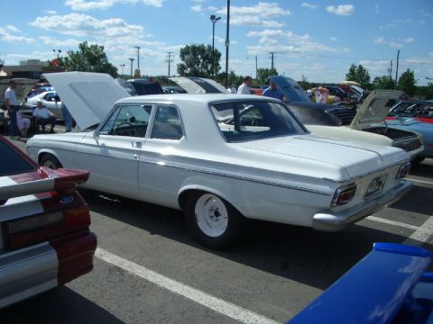 1970 Ford Mustang - A white 1963 Plymouth Belvedere is displayed with its hood open at an outdoor car event.